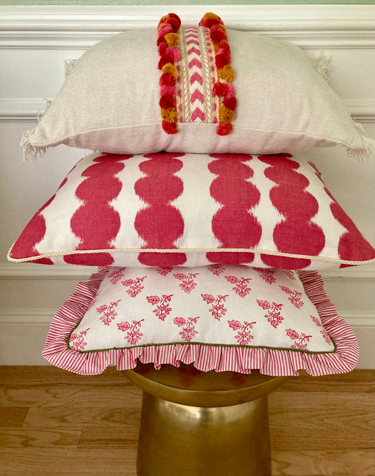 Schumacher pink and white ruffle pillow with green micro piping