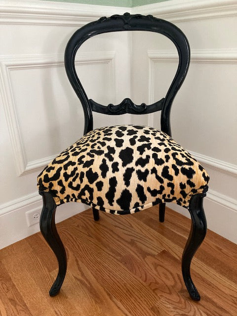 Black glossy vintage chair with velvet cheetah